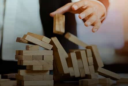 Home 16 Businessman hand with blocks falling