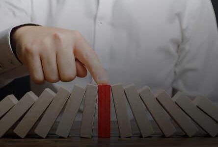 Home 15 Businessman holding blocks with red block in middle