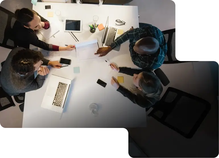 Overhead view of business people working at large desk