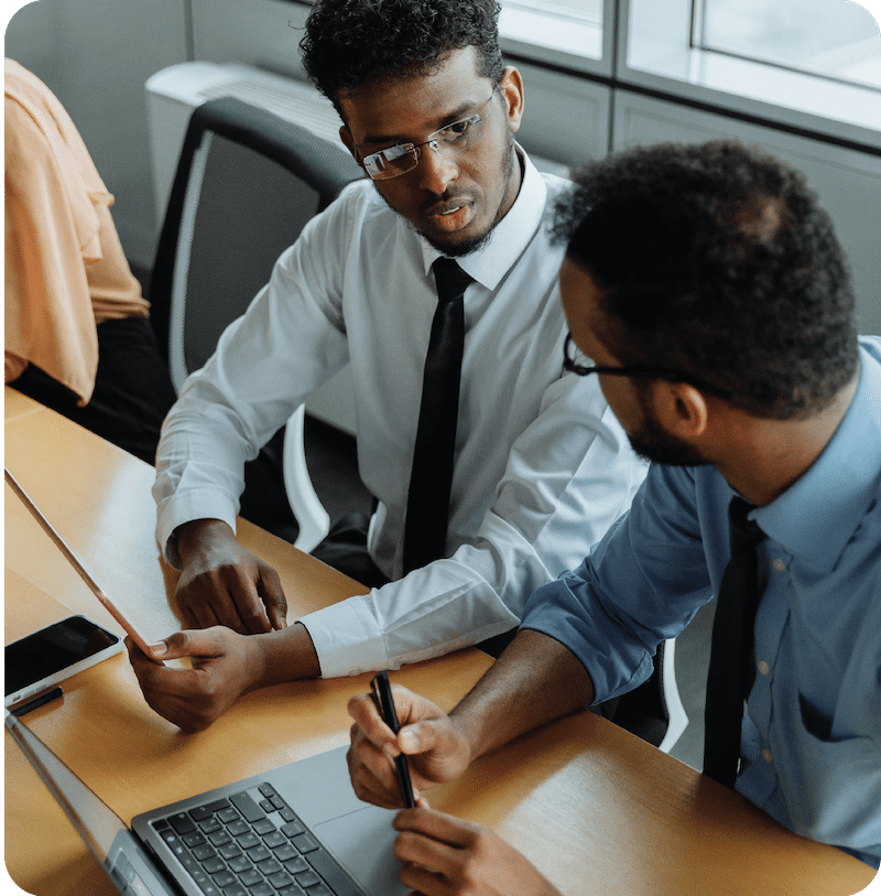 Two professionals at conference table working together