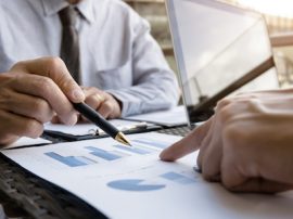 Business Executives discussing about sales performance at a modern outdoor workplace. Business Executives discussing about sales performance at a modern outdoor workplace.